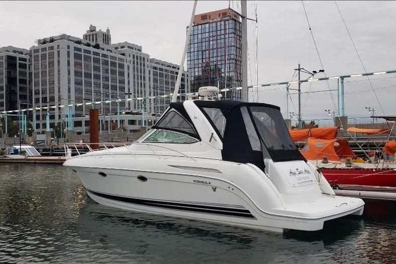 The Image of 2004 Formula 37 Performance Cruiser docked in urban marina setting. - 0