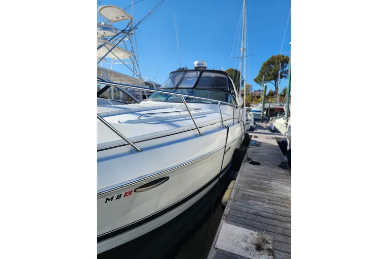 Slide: The Image of 2004 Formula 37 Performance Cruiser docked at marina under clear blue sky. - 2