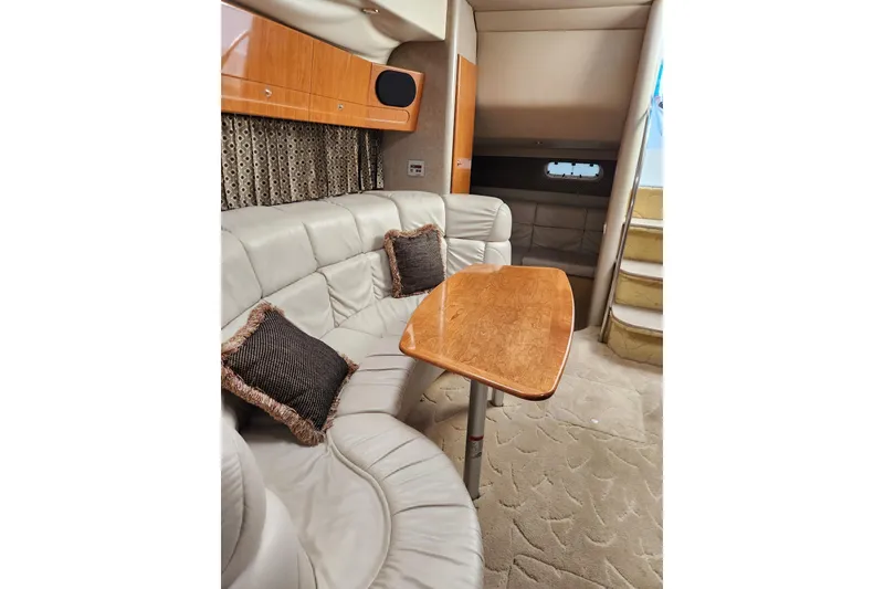 Slide: The Image of 2004 Formula 37 Performance Cruiser interior with plush seating and wooden table. - 4