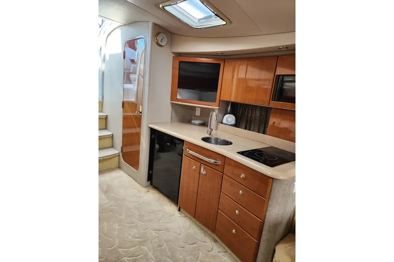 Slide: The Image of 2004 Formula 37 Performance Cruiser interior kitchen with wood cabinets and modern appliances. - 5