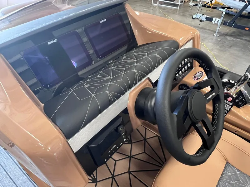 Slide: The Image of 2024 Harris 250 Grand Mariner V10 400 boat dashboard with modern controls and steering wheel. - 10