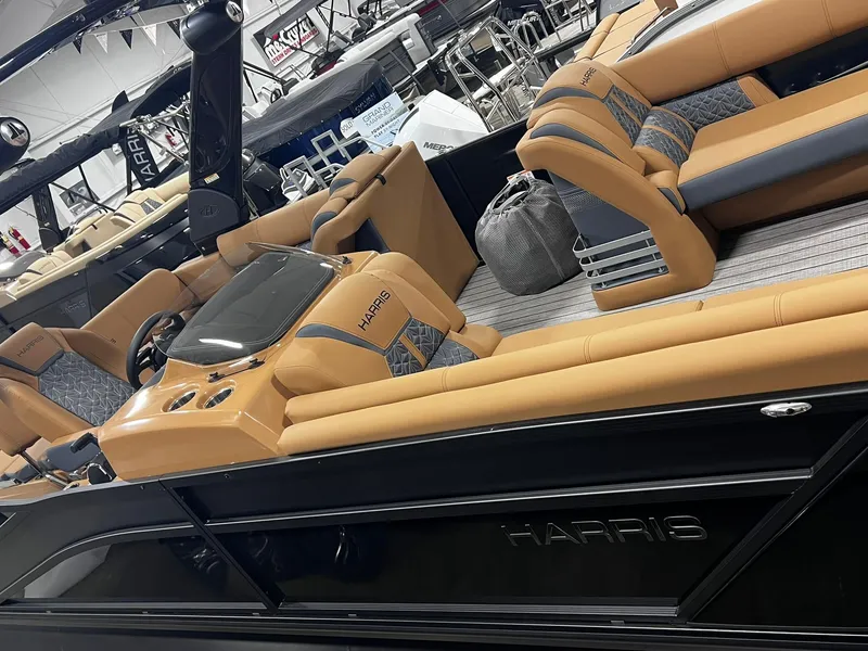 Slide: The Image of 2024 Harris 250 Grand Mariner V10 400 luxury boat interior with tan seating. - 14