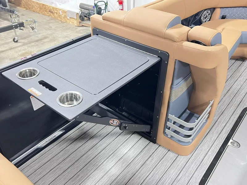 Slide: The Image of 2024 Harris 250 Grand Mariner V10 400 interior with foldable table and cup holders. - 17
