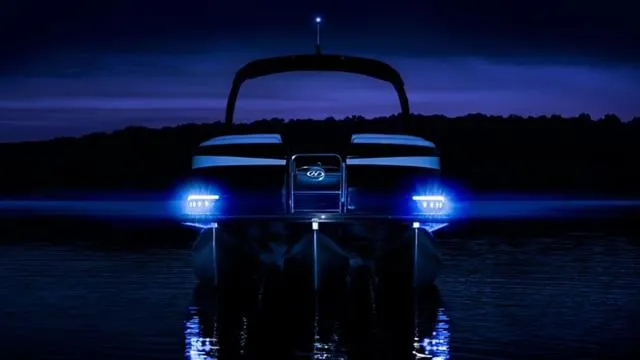 Slide: The Image of 2024 Harris 250 Grand Mariner V10 400 pontoon boat illuminated at night on water. - 39