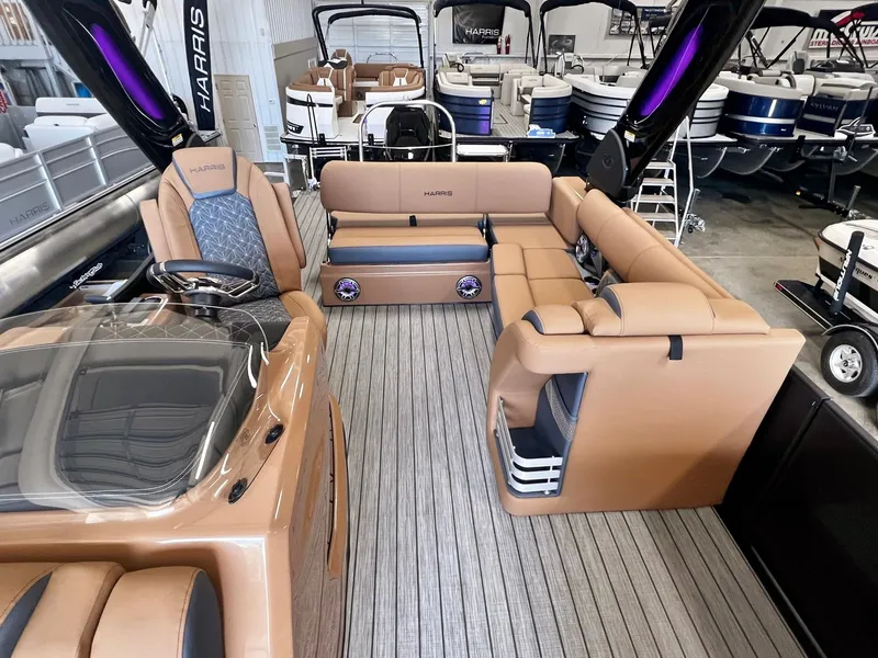 Slide: The Image of Luxurious 2024 Harris 250 Grand Mariner V10 400 pontoon boat interior with plush seating. - 5