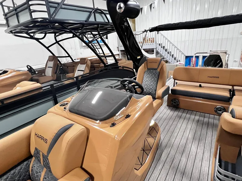 Slide: The Image of 2024 Harris 250 Grand Mariner V10 400 luxury boat interior with tan seating and sleek design. - 8