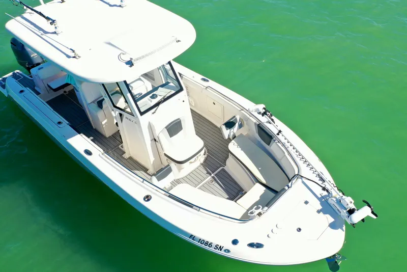 Slide: The Image of 2020 Robalo R272 Center Console boat on clear green water, aerial view. - 10