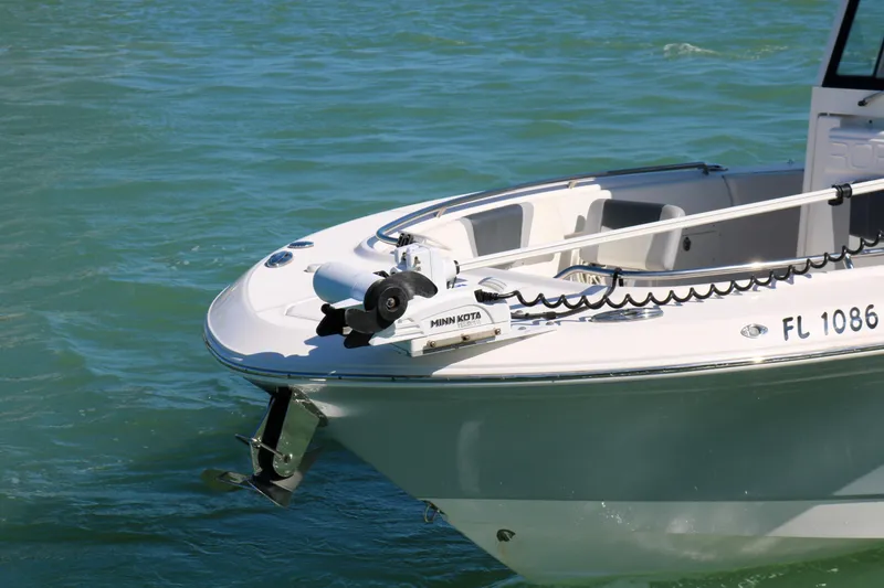 Slide: The Image of 2020 Robalo R272 Center Console boat on water, featuring Minn Kota trolling motor. - 14