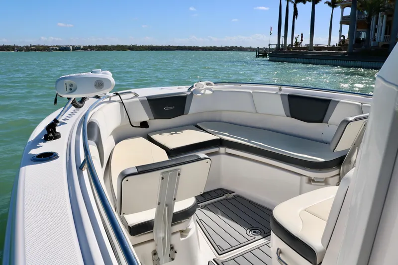 Slide: The Image of 2020 Robalo R272 Center Console boat interior with seating, on a sunny day by the water. - 16