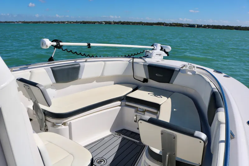 Slide: The Image of 2020 Robalo R272 Center Console boat interior with seating, on calm blue water. - 17