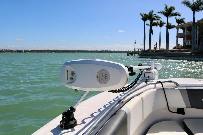 Slide: The Image of 2020 Robalo R272 Center Console boat with trolling motor on sunny waterfront. - 20