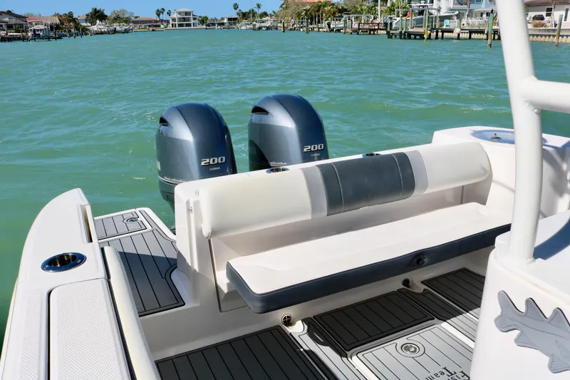 Slide: The Image of 2020 Robalo R272 Center Console boat with twin 200 horsepower engines on calm water. - 21