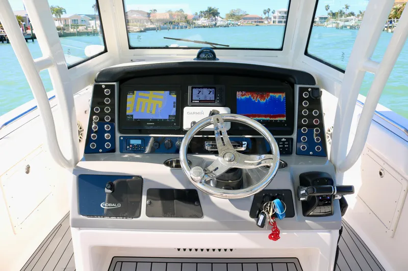 Slide: The Image of 2020 Robalo R272 Center Console boat dashboard with navigation and control systems. - 25
