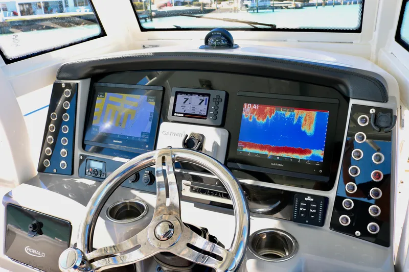 Slide: The Image of 2020 Robalo R272 Center Console dashboard with Garmin displays and steering wheel. - 27