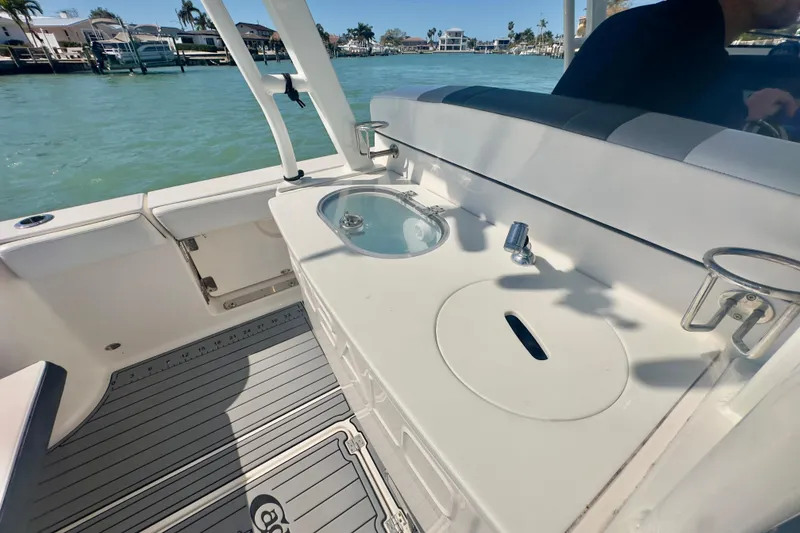 Slide: The Image of 2020 Robalo R272 Center Console boat with sink and cup holders on deck. - 32