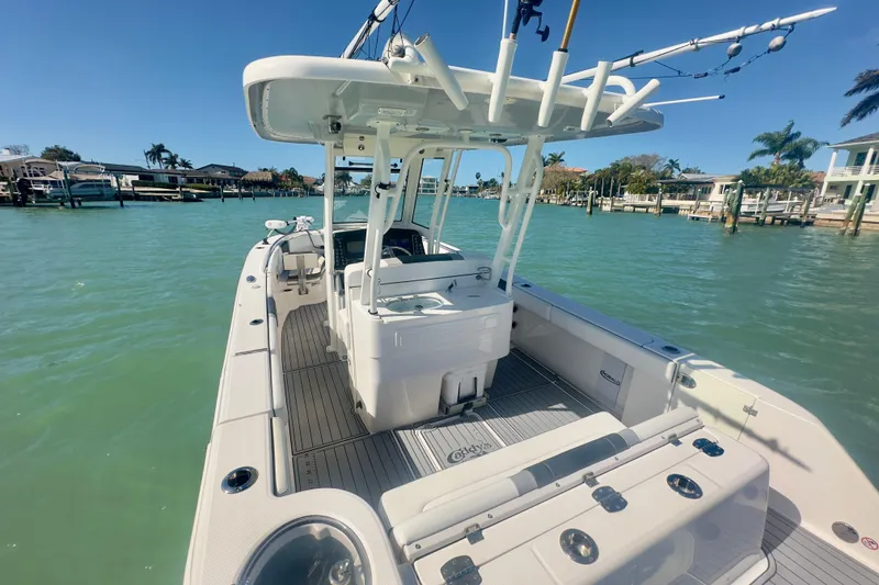 Slide: The Image of 2020 Robalo R272 Center Console boat on calm water, sunny day, coastal background. - 33