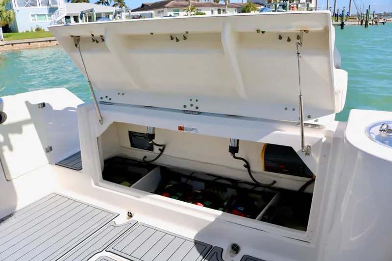 Slide: The Image of 2020 Robalo R272 Center Console with open storage compartment by the water. - 34