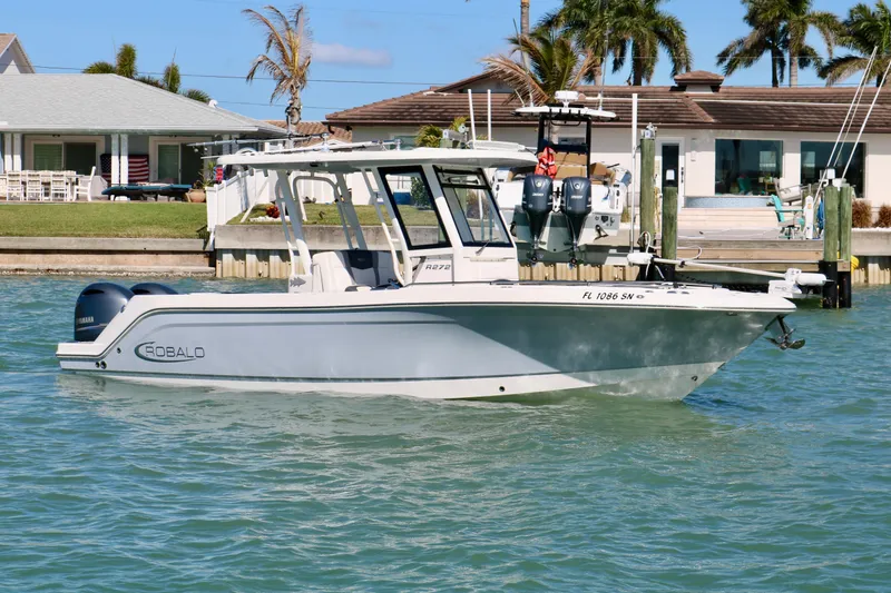 Slide: The Image of 2020 Robalo R272 Center Console boat on water near waterfront homes. - 4