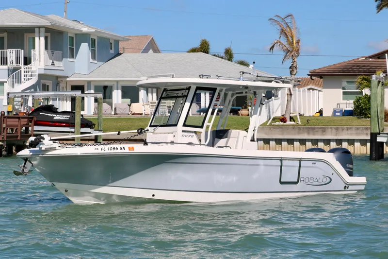 Slide: The Image of 2020 Robalo R272 Center Console boat on water near waterfront homes. - 8