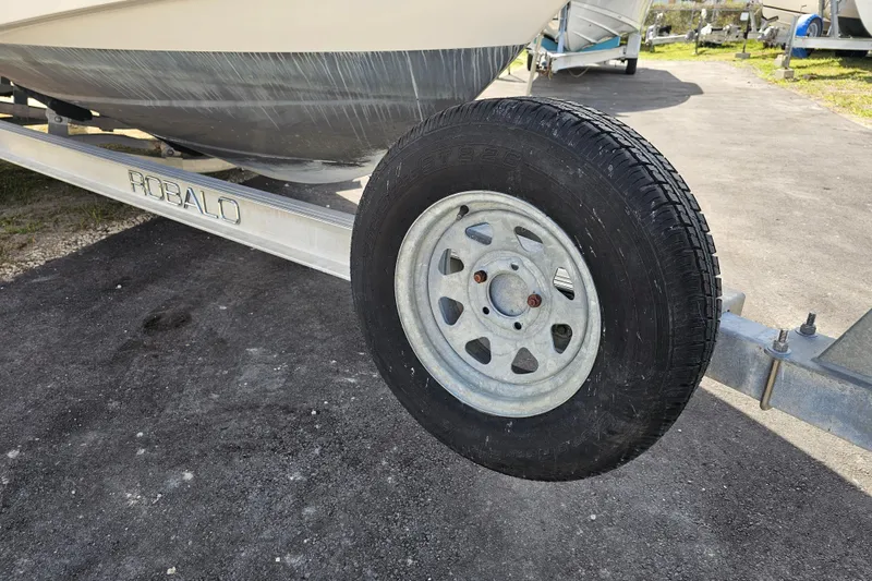 Slide: The Image of 2015 Robalo R222 Center Console boat deck with seating and storage compartment. - 10