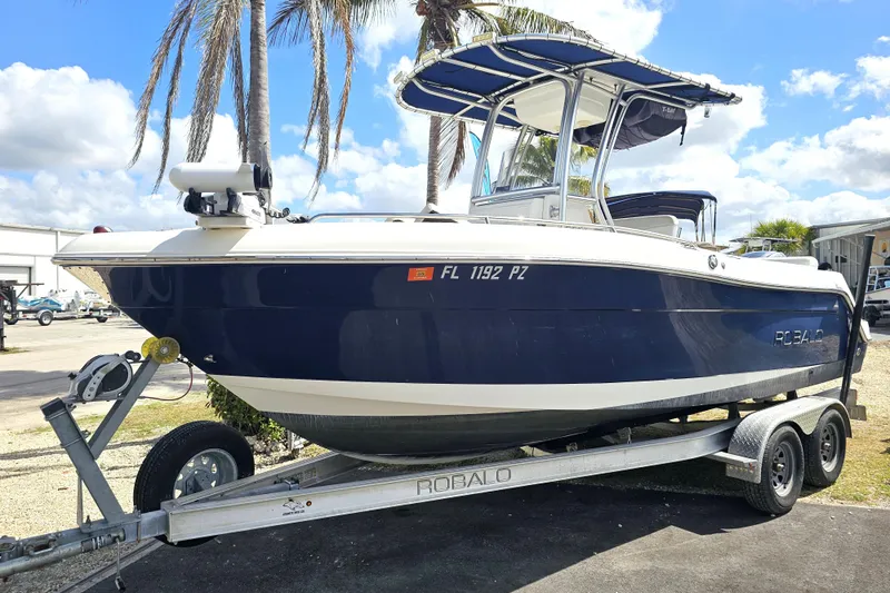 Slide: The Image of 2015 Robalo R222 Center Console boat interior with cushioned seating and speaker. - 16