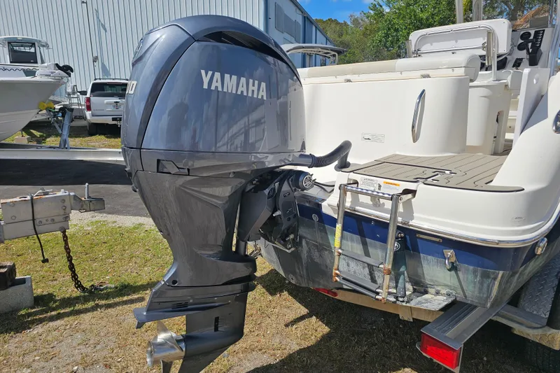 Slide: The Image of 2015 Robalo R222 Center Console boat seat with beige and white upholstery. - 18