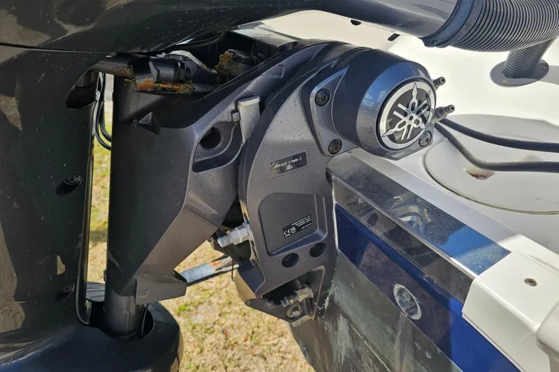 Slide: The Image of 2015 Robalo R222 Center Console storage compartment with safety equipment and battery. - 19