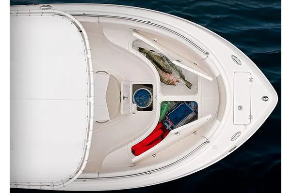Slide: The Image of 2015 Robalo R222 Center Console boat on trailer, parked outdoors. - 2