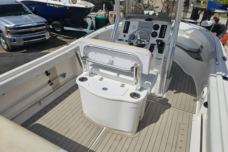 Slide: The Image of Open storage compartment on 2015 Robalo R222 Center Console boat with orange bag and rope. - 22