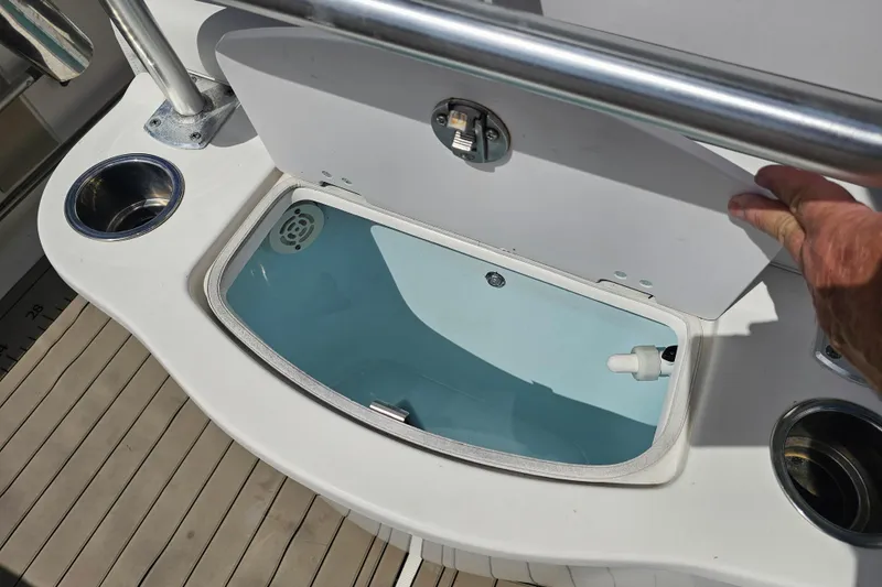 Slide: The Image of Open storage compartment on 2015 Robalo R222 Center Console boat. - 23