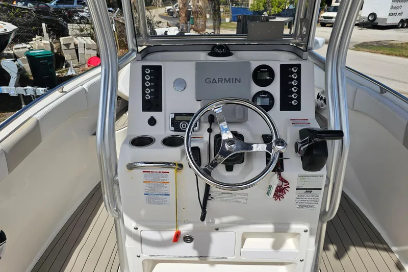 Slide: The Image of 2015 Robalo R222 Center Console boat interior with seating and Yamaha engine. - 24