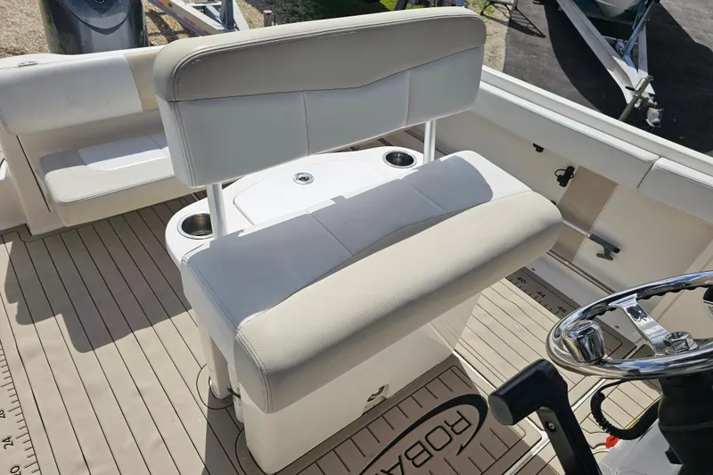 Slide: The Image of Open storage compartment on 2015 Robalo R222 Center Console boat with orange bag inside. - 26