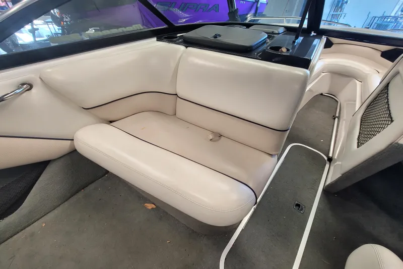 Slide: The Image of 2003 Malibu Sunsetter LXi boat interior with white leather seating and carpeted floor. - 13