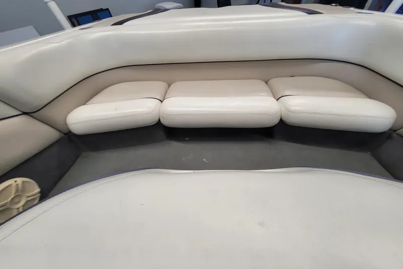 Slide: The Image of 2003 Malibu Sunsetter LXi boat interior with white cushioned seating. - 14