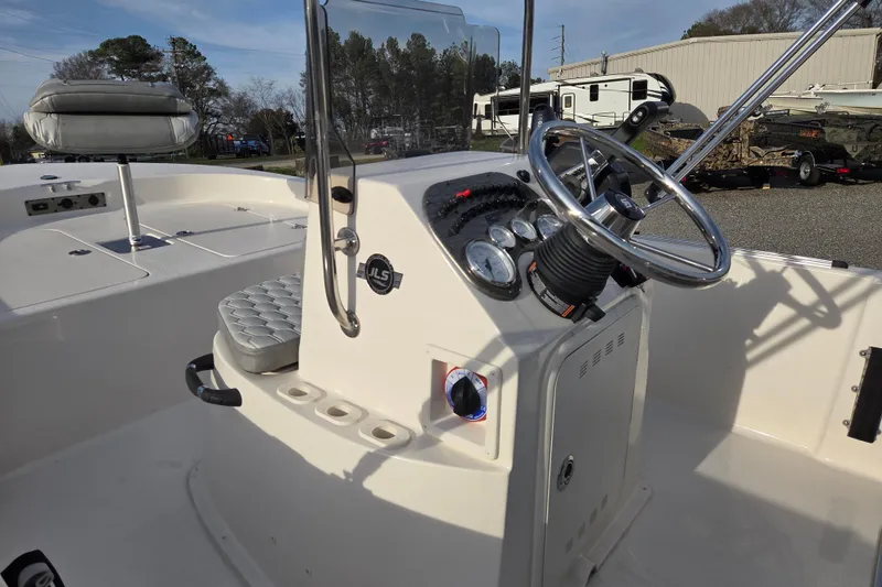 Slide: The Image of 2026 Carolina Skiff 178 JLS boat interior with steering console and seating. - 17