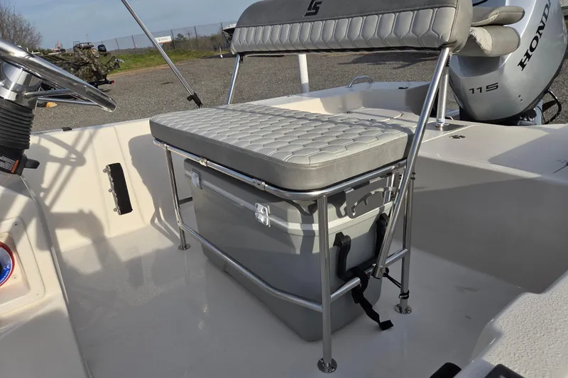 Slide: The Image of 2026 Carolina Skiff 178 JLS boat interior with seating and Honda outboard motor. - 19