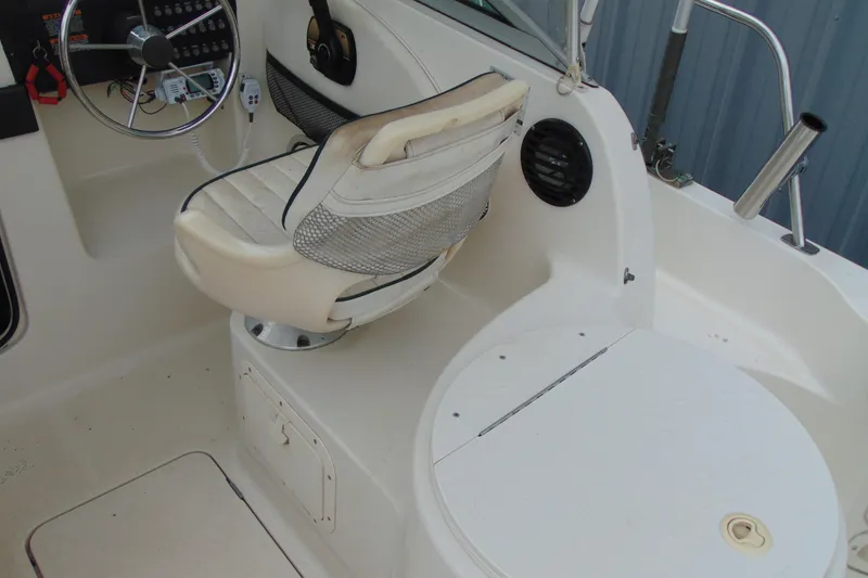 Slide: The Image of 2000 Bayliner 2302 Trophy Walkaround DX/LX boat interior with steering wheel and seating. - 11