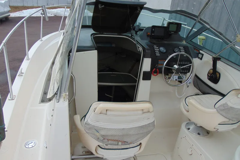 Slide: The Image of 2000 Bayliner 2302 Trophy Walkaround DX/LX boat interior with helm and seating. - 14