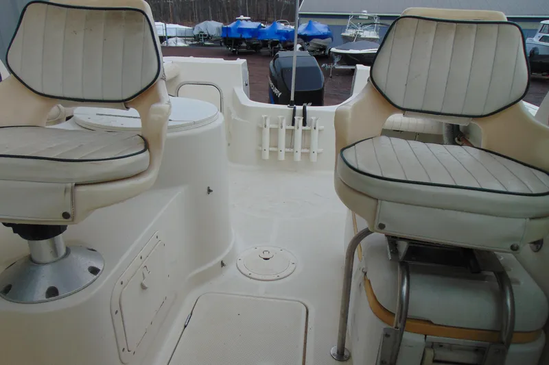 Slide: The Image of 2000 Bayliner 2302 Trophy Walkaround DX/LX boat interior with two cushioned seats. - 16