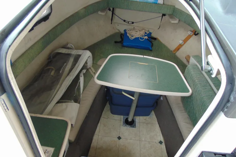 Slide: The Image of 2000 Bayliner 2302 Trophy Walkaround DX/LX cabin interior with table and seating. - 17