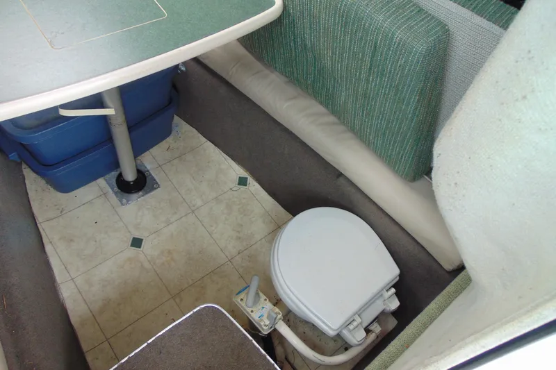 Slide: The Image of Interior of 2000 Bayliner 2302 Trophy Walkaround DX/LX with table and marine toilet. - 20
