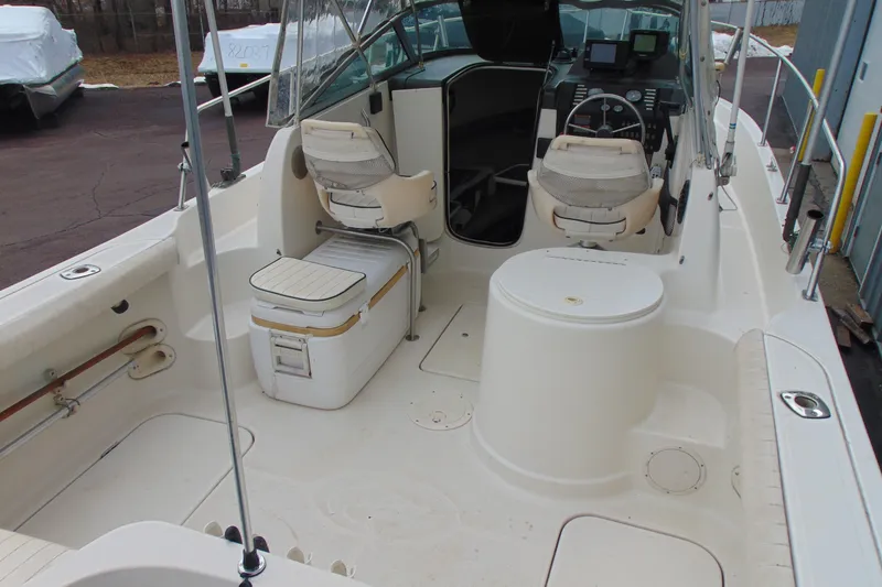 Slide: The Image of 2000 Bayliner 2302 Trophy Walkaround DX/LX boat interior with seating and dashboard. - 7