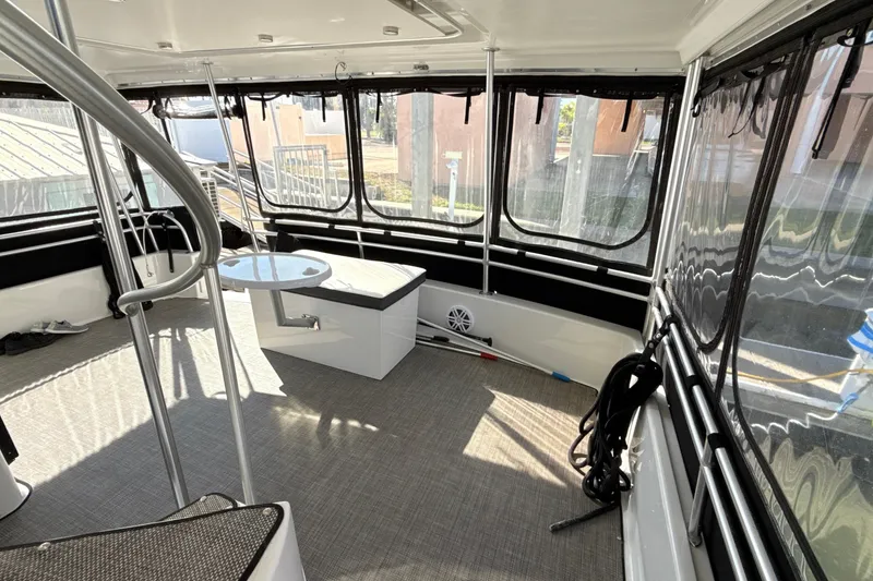 Slide: The Image of 1998 Mainship 47 Motor Yacht interior with seating, table, and windows. - 24