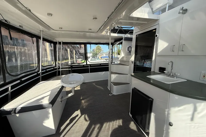 Slide: The Image of Interior of 1998 Mainship 47 Motor Yacht with seating, kitchenette, and spiral staircase. - 27