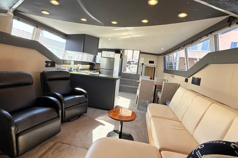 Slide: The Image of Interior of 1998 Mainship 47 Motor Yacht with modern seating and kitchen area. - 37