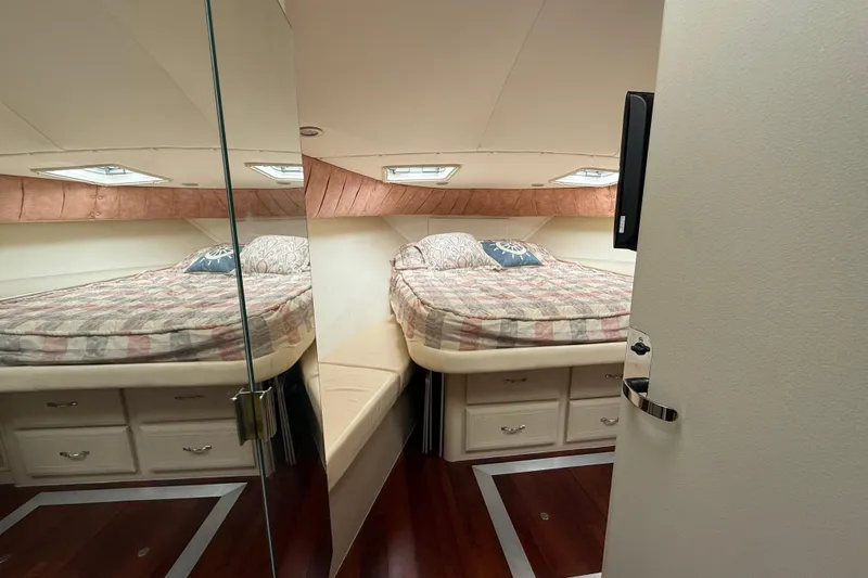 Slide: The Image of 1998 Mainship 47 Motor Yacht bedroom with cozy bed and storage drawers. - 56