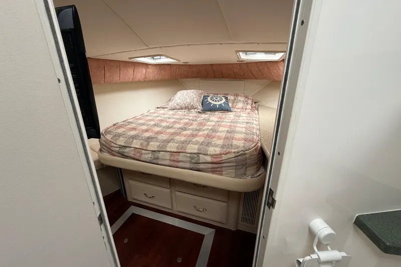 Slide: The Image of Cozy bedroom in 1998 Mainship 47 Motor Yacht with plaid bedding and nautical decor. - 59
