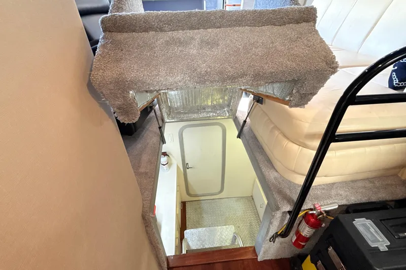 Slide: The Image of Interior view of 1998 Mainship 47 Motor Yacht, featuring stairs and cozy seating area. - 60