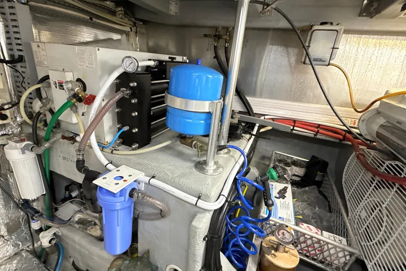 Slide: The Image of Engine room of a 1998 Mainship 47 Motor Yacht with various mechanical components. - 78