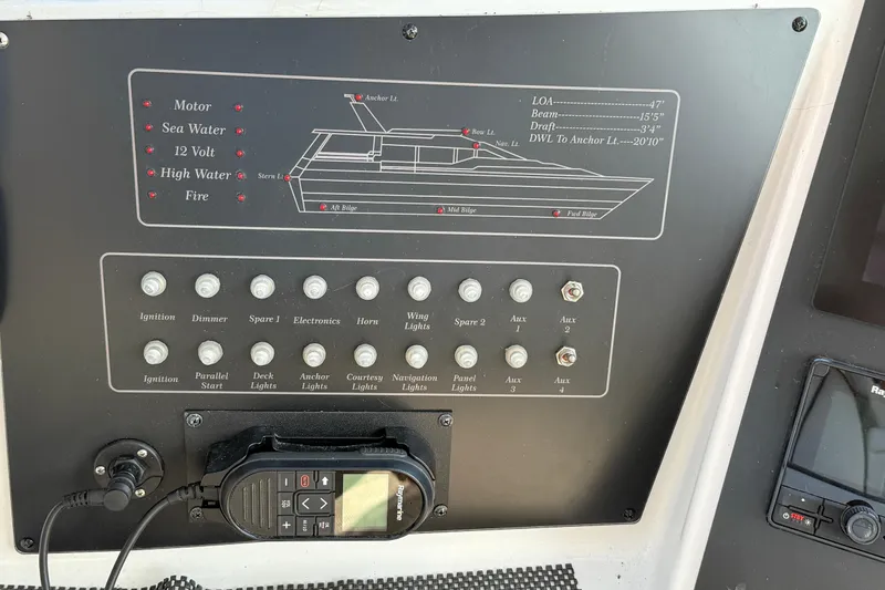 Slide: The Image of Control panel of a 1998 Mainship 47 Motor Yacht with various switches and indicators. - 9